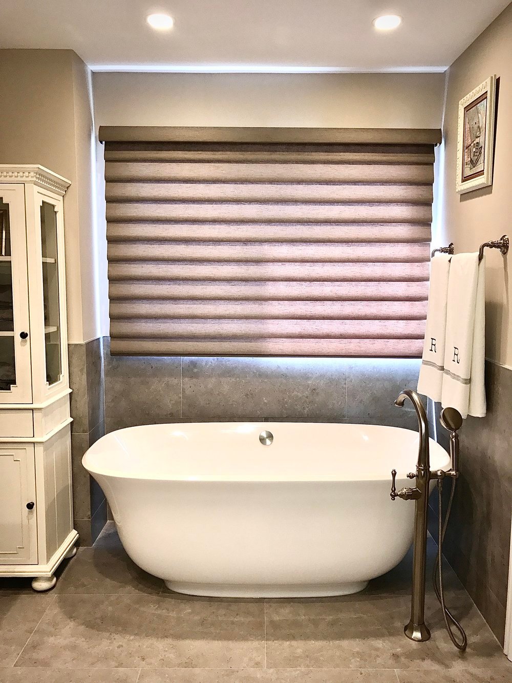 This luxury bathroom design features a seamless glass shower, bold black marble vanity, and vessel sink. A striking example of modern bathroom design, it balances functionality with sophisticated style. Perfect for those seeking a timeless bathroom design with upscale details.