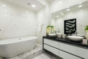 Bathroom Design 7 This high-end bathroom design includes a double vanity, marble backsplash, and under-cabinet lighting. With thoughtful layout design and luxurious finishes, this space feels custom-built for comfort and beauty. A top choice for those exploring bathroom designs that impress.
