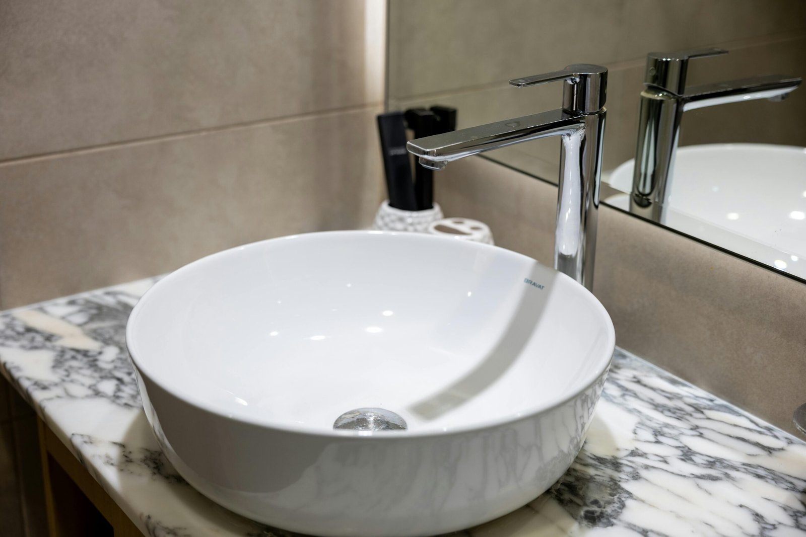 Elegant and timeless bathroom design with a standalone soaking tub, chandelier, and arched window detail. Every element is chosen to reflect timeless bathroom design with a hint of luxury. A standout choice for classic yet functional remodeling projects.
